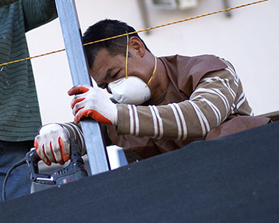 Handyworker program worker installing metal fence for patio